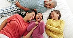 Happy, bed and children relaxing with their parents while tickling, playing and bonding together. Happiness, laughing and girl kids lying with their mother and father in the bedroom of family home.