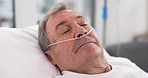 Oxygen, hospital bed and senior man sleeping with ventilation and breathing tube support in a clinic. Elderly patient, medical care and emergency room with male person at a doctor for healthcare