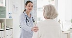 Woman, doctor and consulting senior patient in care, support or trust for checkup appointment at hospital. Happy female person or medical healthcare professional talking to elderly customer at clinic