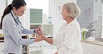 Woman, doctor and senior patient in consultation for checkup, appointment or exam at hospital. Female person or medical professional checking elderly customer in care, support or trust at the clinic