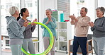 Fitness, senior and people with celebration at gym at end or exercise class for wellness. Elderly, group and friends in studio to congratulation after workout in retirement with coach and hula hoop.