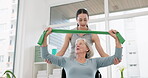 Senior woman with disability, physiotherapy and stretching band for muscle rehabilitation, healthcare assessment and chiropractor services. Physiotherapist, medical support and patient in wheelchair