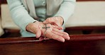 Rosary, prayer or hands of woman in church for God, holy spirit or religion with faith in Christian cathedral. Jewelry closeup, spiritual lady or person in chapel praying to praise Jesus Christ alone