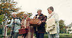 Walking, picnic and senior friends in the park together for bonding or conversation during retirement. Smile, basket and a group of happy elderly people in a garden for freedom, fresh air to relax