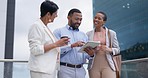 Business people on balcony in city with tablet, discussion and brainstorming ideas for startup company. Conversation, online report or feedback with team, man and women on terrace working together.