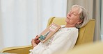 Relax, book and senior woman sleeping in the living room of her modern house on a weekend. Calm, peace and elderly female person in retirement taking a nap after reading a story or novel at home.