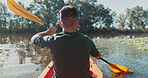 Kayak, lake and back view of man on an adventure to explore the water by rowing while camping in nature. Boat, canoe and person in a river for vacation or holiday in the countryside for freedom