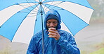 Rain, umbrella and coffee with black man in nature for travel, hiking and adventure. Calm, freedom and winter storm with portrait of person in countryside woods for health, camping and trekking