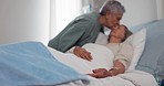 Elderly women, hospital and kiss on forehead for care, kindness and support, comfort and empathy for hope. Senior people, love and affection of patient with cancer, sick or disease on bed in clinic