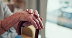 Closeup, hands and cane with old woman, support and relax with cancer, retirement and resting. Zoom, elderly lady and senior female person with a walking stick for balance, home and health problem