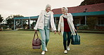 Retirement, hobby and senior woman friends walking on a field at the bowls club together for a leisure activity. Smile, talking and elderly people on the green of a course for bonding or recreation