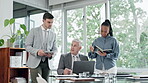 Laptop, training and a senior manager with his team in the boardroom for coaching during a workshop. Computer, management or education with a CEO business man and his staff meeting in the office