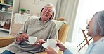 Senior women friends, tea and chat in living room for laugh, gossip or relax on chair in retirement. Elderly lady, conversation and together with coffee cup, funny story or comic joke in nursing home