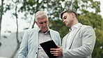 Senior businessman, tablet and teamwork in outdoor, park or walking in a garden in the city for networking, crm or b2b conversation. Entrepreneur, mentor or employee teaching strategy or planning