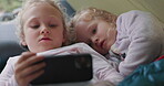 Phone, bed and children together for internet connection while steaming movies online. Sibling, kids or friends play on a smartphone for mobile app, learning content and family games for education