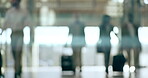 Travel, airport and business people walking with luggage in a terminal for an international trip. Corporate, transport and flight with a group of professional people getting ready for departure