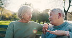 Park, conversation and senior women at park on bench to relax in outdoor with lens flare. Nature, retirement and elder female friends are talking in garden for quality time or bond in environment.