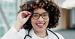 Face, happy doctor and woman with glasses in hospital for healthcare, wellness and insurance. Medical professional, portrait and surgeon smile, expert and employee from South Africa in health clinic