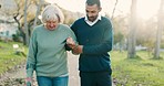 Walking, crutch and man with his elderly mother in a park for support, help or balance in nature. Medical, wellness and young male person doing a cardio exercise with his senior mom in outdoor garden