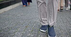 Walking, sidewalk and legs of a person in the city for travel, commute or morning in the street. Closeup, moving and feet or shoes of a person in the road for outdoor movement in a busy town