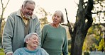 Walking, nature and friends with a woman in a wheelchair for conversation, support and care. Summer, happy and an elderly man and people with a disability in a park for fresh air, love or talking