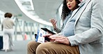 Talking, business people and ticket at the airport for travel, planning on tech and waiting for a flight. Corporate, speaking and employees sitting together with a boarding pass and tablet for a trip