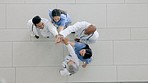 High five, applause or excited doctors, people or group celebrate success, team building solidarity or hospital achievement. Top view, winner or medical staff cooperation, teamwork or congratulations