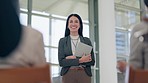 Tablet, applause and a business woman giving a speech in the boardroom for training or coaching. Technology, presentation and a female speaker talking to an audience during a seminar or workshop