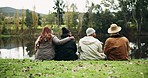 Friends, back and camping in nature, river or relax together for peace, countryside view or outdoor. People, group and sitting on field, grass and watch in forest, lake or water for holiday adventure