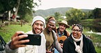 Selfie, camping and friends at a forest lake bond, happy and and enjoying guitar and drinks in nature. Smartphone, profile picture and group of people relax in woods, fun and enjoy freedom at river