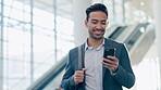 Phone, happy and business man at airport lobby for social media, search app or email. Smile, smartphone and Asian professional with bag or luggage for travel, communication and consultant walking