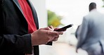 Phone, closeup and businesswoman typing in the city for networking on social media or the internet. Technology, online and female person browsing on a mobile app with a cellphone in an urban town.