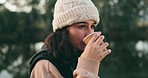 Face, thinking and camping with a woman drinking coffee outdoor while in nature for travel, freedom or adventure. Idea, hiking and vacation with a young female tourist in the forest or woods closeup