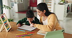 Teaching, woman and child with math in home, living room or boy with homework, writing and learning at table. Education, development and kid learning, writing or tutor or mom helping with work