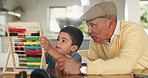 Abacus, math and grandfather with child for learning, studying and teaching for development. Education, school and grandparent helping boy in home for knowledge, growth and studying for lesson