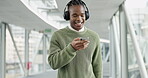 Music, happy and business with black man and phone for streaming, social media and radio. Podcast, technology and headphones with male employee dancing in office building for audio and mobile app