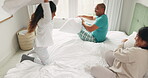 Happy, love and pillow fight with family in bedroom for playful, morning and relax. Happiness, support and funny with parents and child playing in bed at home for games, wake up and excited together