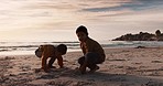 Digging, playing and children at the beach for the sand and silhouette at sunset on vacation. Morning, nature and kids or friends at the ocean for bonding, quality time or childhood on holiday