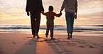 Family, beach at sunset and holding hands, travel and ocean with people bonding on tropical holiday. Mother, father and child spending time together outdoor, nature and walk with adventure back view