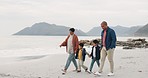 Grandmother, father and kids walking on beach, holding hands and travel by the ocean, trust and bonding outdoor. Winter, nature and people on adventure, family and freedom on journey with love