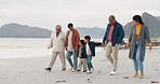 Beach, travel and big family holding hands while walking together on vacation, holiday or adventure. Happy, love and boy children bonding with grandparents and parents by the ocean on a weekend trip.