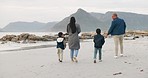 Beach, walking and back of parents with their children on vacation, holiday or adventure. Love, travel and boy kids bonding with their mother and father by the ocean on a family weekend trip.