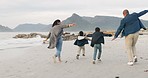 Playful, beach and family running together with energy while on holiday, vacation or adventure. Freedom, playing and boy children having fun and bonding with their parents by ocean on a weekend trip.