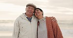 Old couple, hug and talking while at beach, happiness and retirement together, travel and freedom outdoor. Communication, happy people and pension with holiday, marriage and commitment with sunset