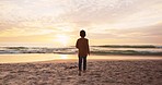 Beach, sunset and child at waves, running and playing on tropical holiday with fun, freedom and energy. Sky, nature and ocean vacation, kid playing on sand in evening and happiness at sea in Hawaii.