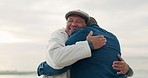 Elderly father, man and hug at beach with love, care and bonding on vacation, holiday or travel outdoor at sunset. Senior dad, adult son and embrace at ocean, sea and happy family talking together