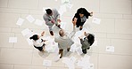 Celebration from above, business people throwing paper in air at project deal achievement meeting. Teamwork, success and diversity, winning target goals in startup office with business profit growth.