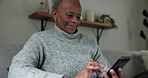 Black woman, elderly and cellphone and typing, chat and communication with social media at home. Using phone, scroll app and internet connectivity, writing texting and relax on couch with retirement