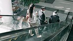 Escalator, morning and business people in office for commute, travel and arrival at work. Corporate workers, professional and men and women for career, job and journey on electric stairs in workplace
