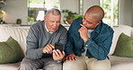 Senior father, man and talking with a phone on a home sofa with help for social media, network or chat. Elderly person with his son in a living room with a smartphone for conversation on internet app